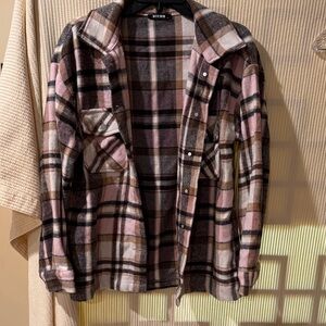 Women’s plaid flannel shacket, a button-down shirt jacket perfect for layering.